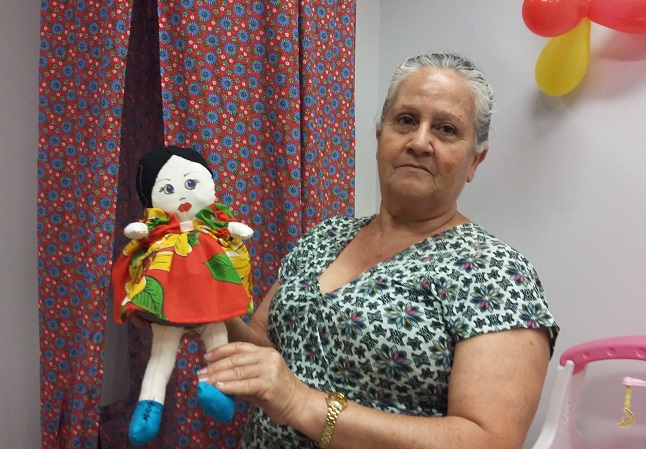 Irene Cândida com uma das bonecas confeccionadas por ela para a Brinquedoteca